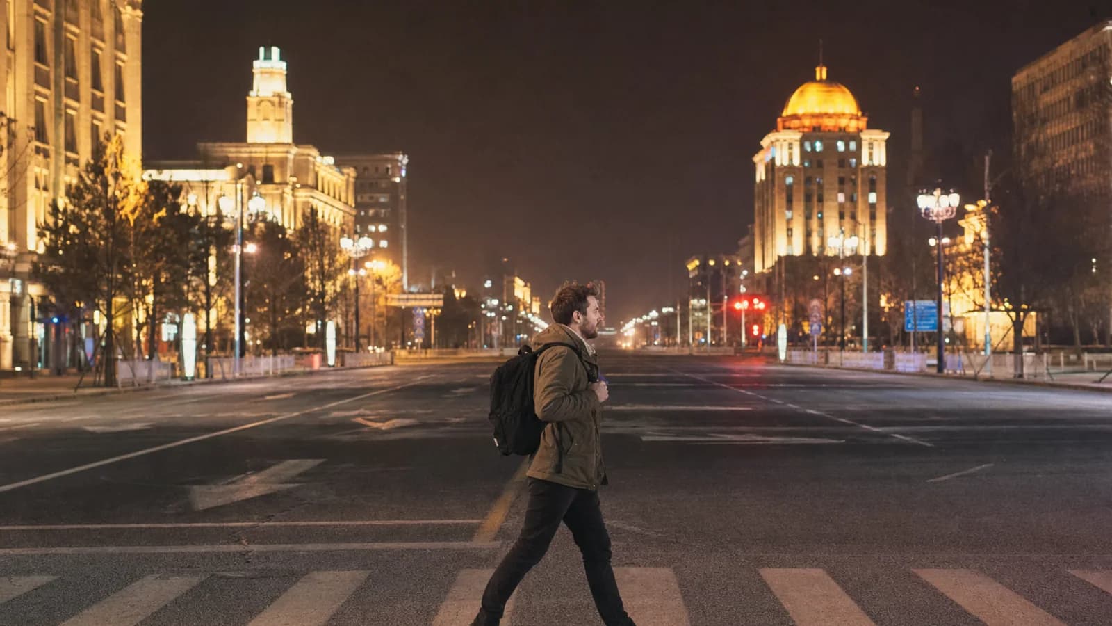 Traveler on wide Changchun street at night