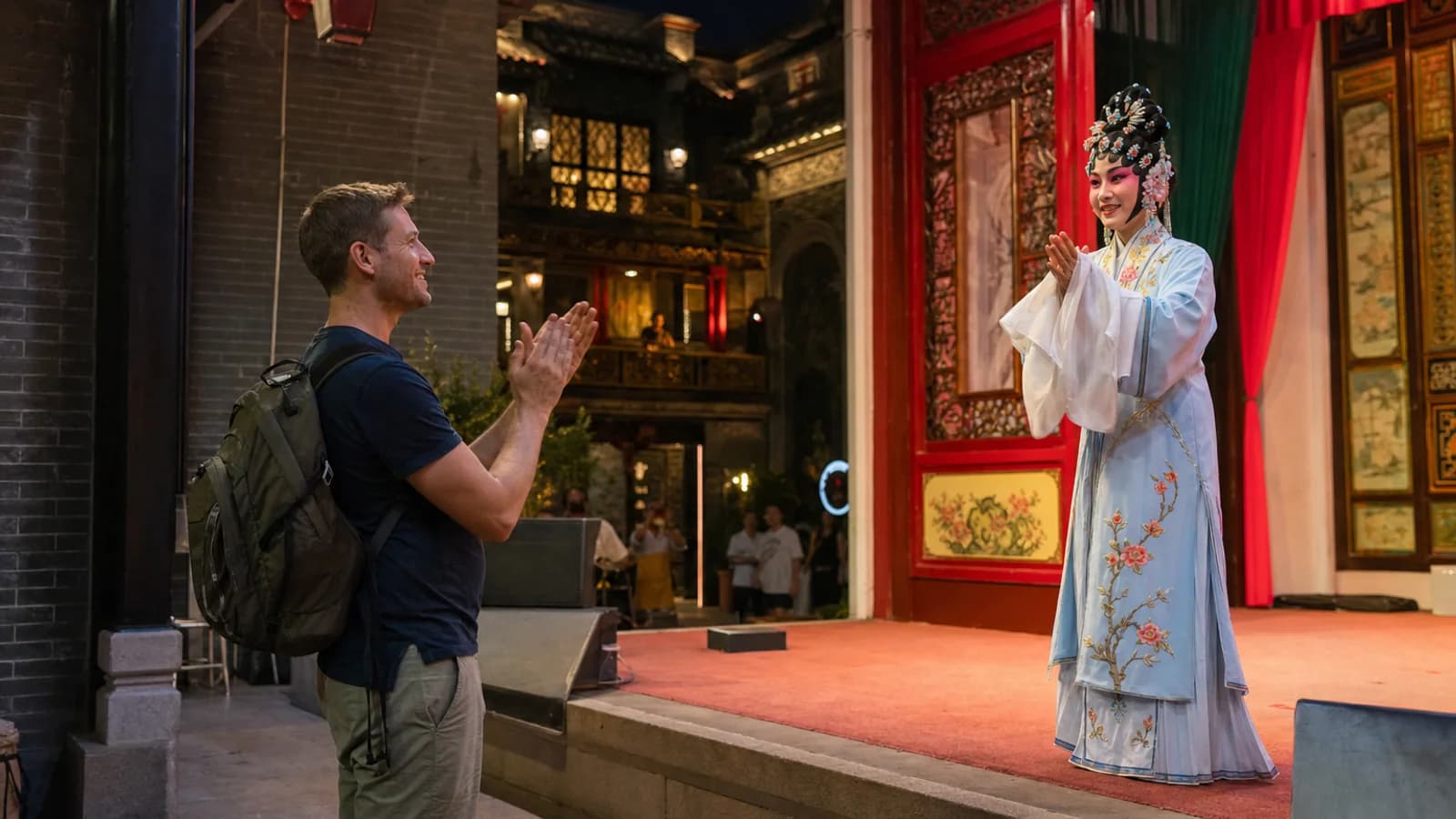 Travelers applauding Cantonese opera