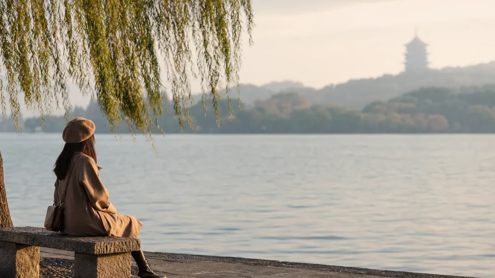 Traveler lingering by misty lake