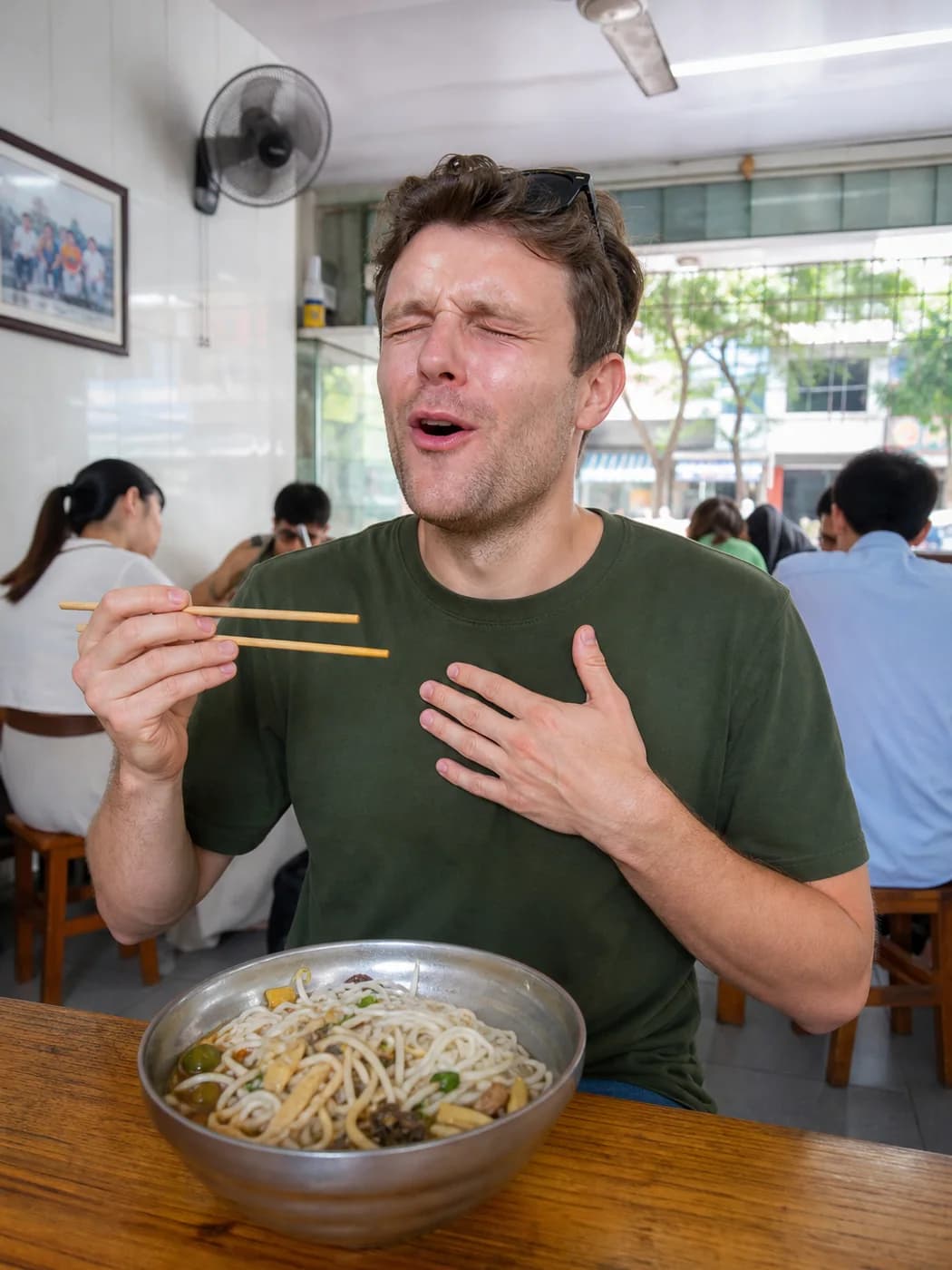 Traveler reacting to sour noodles