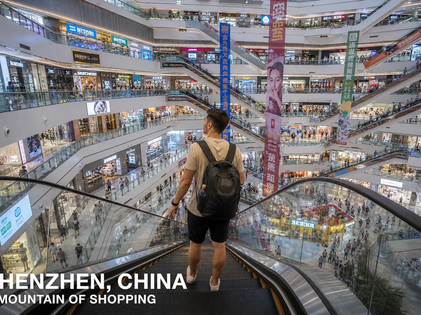 Travelers on long mall escalator