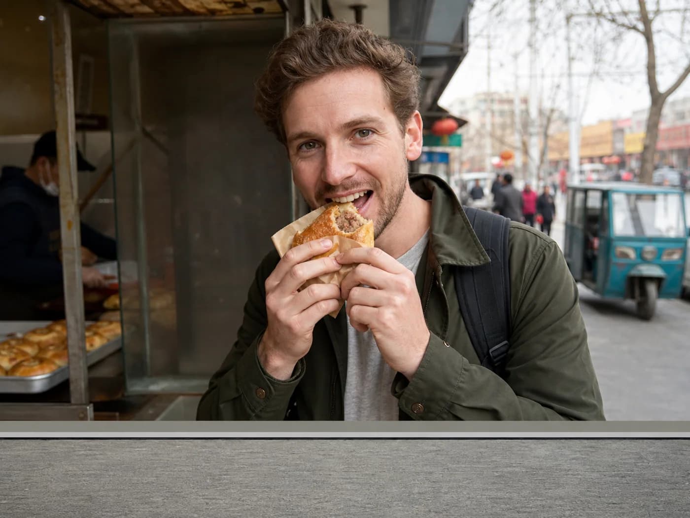 Traveler eating meat pastry walking