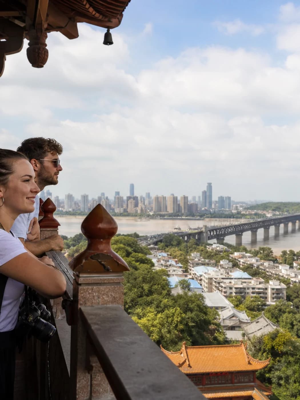 Travelers overlooking Wuhan and the Yangtze from a tower balcony