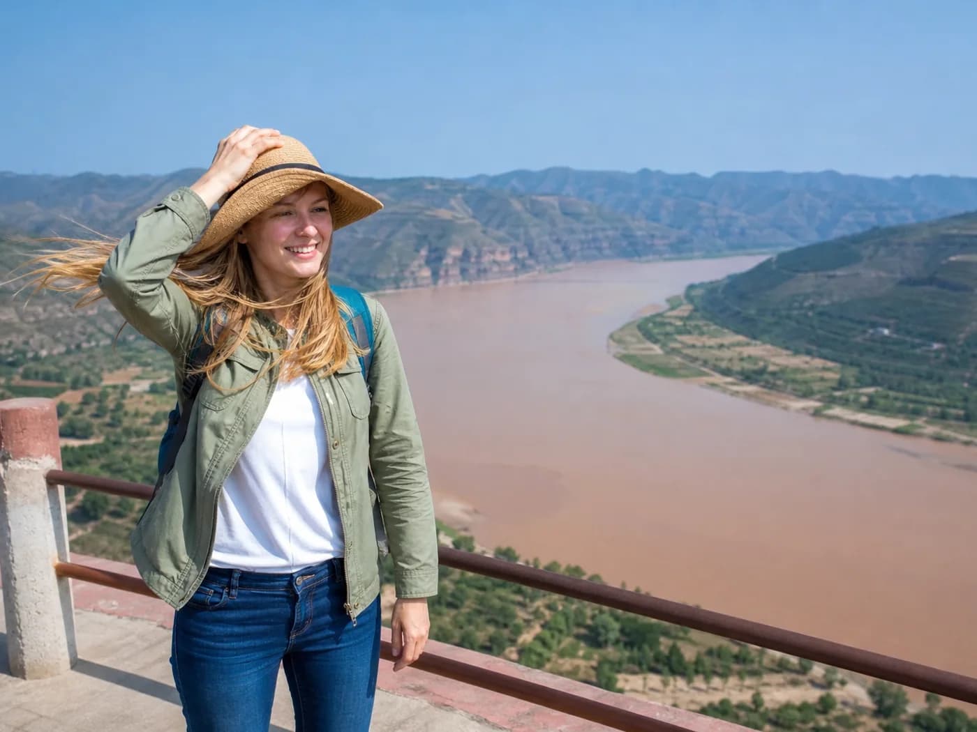 Travelers at windy river viewpoint